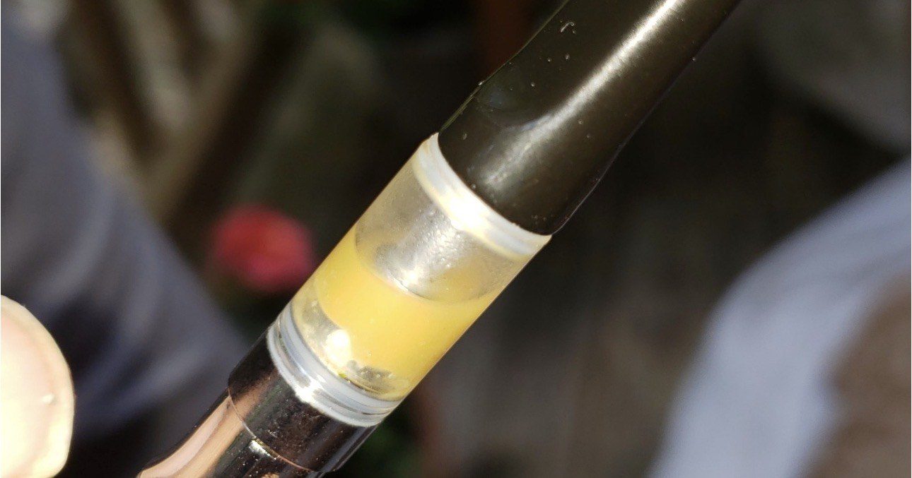 A HALO cartridge filled with golden solventless extract